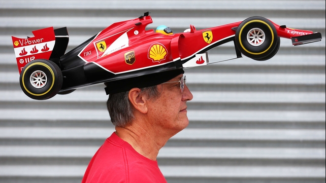 Ferrari fan Kim Reiner walks through the paddock ahead of the Canadian Grand Prix