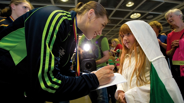 Katie Taylor signs an autograph for Grace Carruth on her triumphant return from the European Championships on Sunday