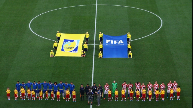 The Brazil and Croatia squads line up before the match kicks off