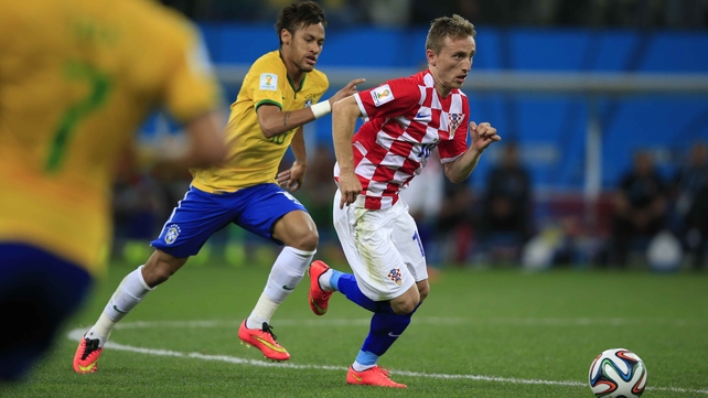 Croatian midfielder Luka Modric drives upfield, while being chased by Neymar