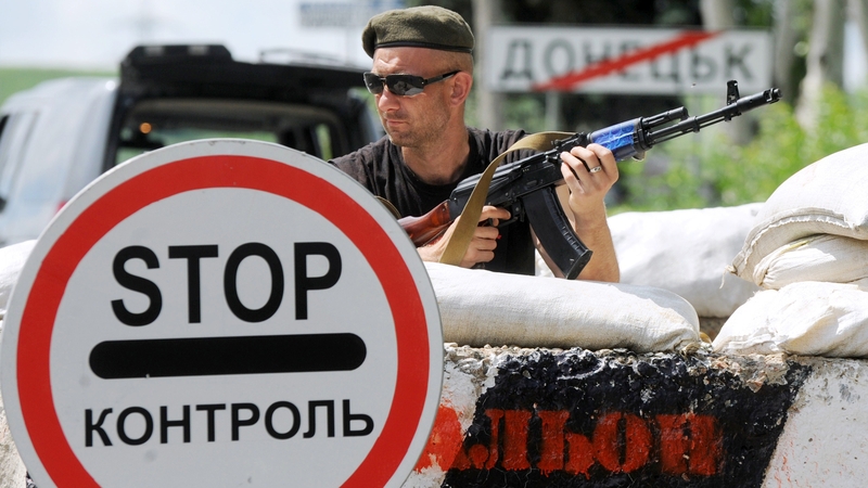 A pro-Russian militant guards a checkpoint on the road between Donetsk and Mariupol earlier this month