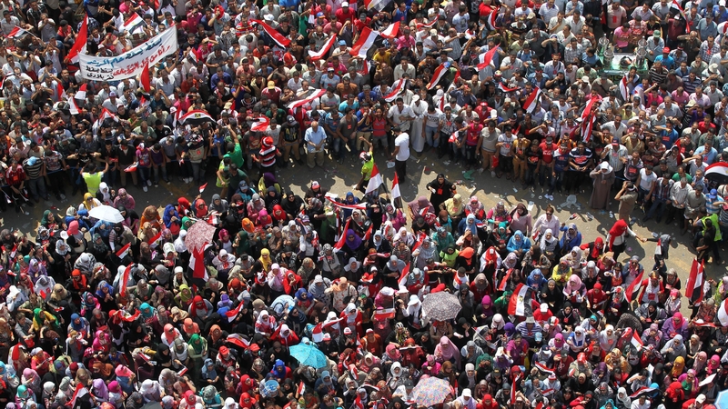 Egyptians wearing fluorescent outfits protecting women from harassment at Tahrir square last year