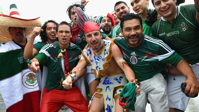 Mexican fans prepare to enter Arena Das Dunas, where their team faced Cameroon- in a tropical rainstorm