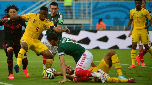 Cameroon's veteran forward Samuel Eto'o works to make something of a chaotic situation on Mexico's goal-line
