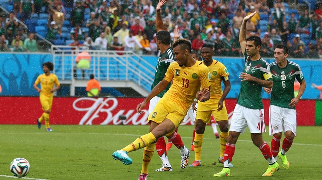 Choupo-Moting shoots on goal, while Mexican players pause play to call him offside (which the line-men did as well)
