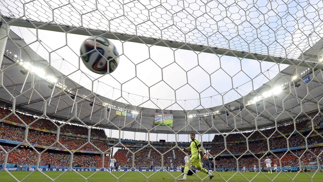 From behind the net, Spanish veteran goalkeeper captain Iker Casillas looks with disbelief as the header floats in