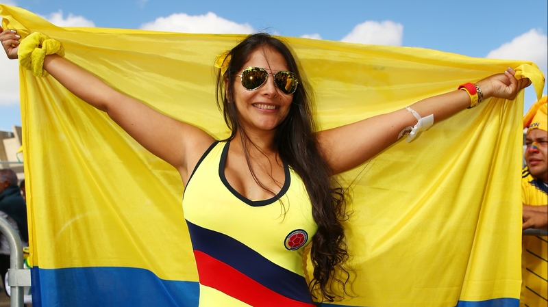 A Colombia fan holds the flag proudly at the start of World Cup Day 3
