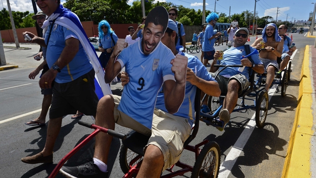 Uruguayan fans drive tricycles carrying a portrait of Luis Suarez, near Castelao Stadium in Fortaleza ahead of Uruguay vs Costa Rica