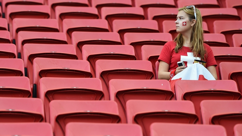 A Swiss fan waits for the game to kick off
