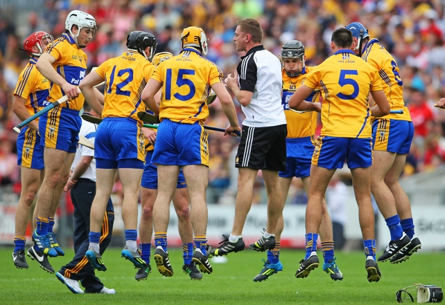 Clare strength and conditioning coach, Joe O'Connor, goes through a warm-up drill with the players before the game against Cork