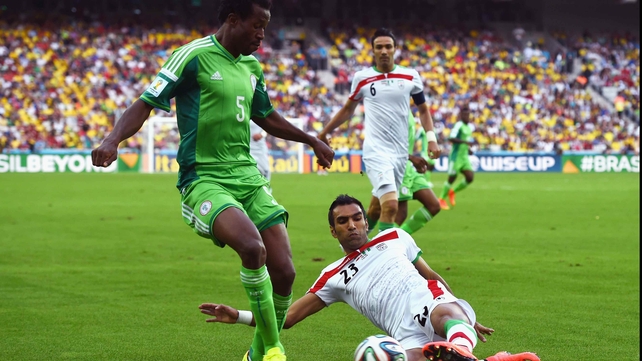 Nigeria defender Efe Ambrose contends with Iran defender Mehrdad Pooladi in a match that featured a balanced, yet blistering start