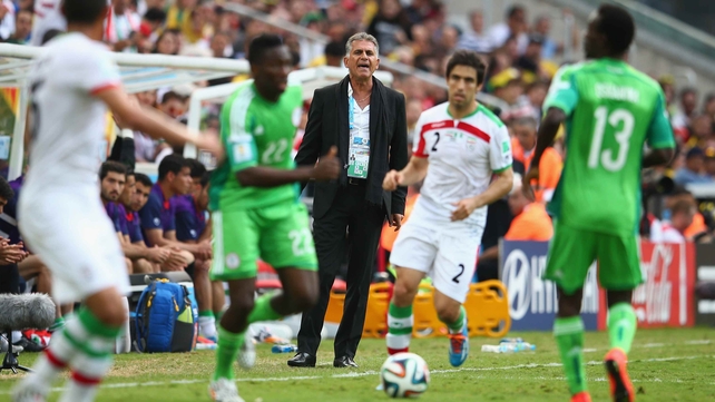 Iran head coach Carlos Queiroz looks on as forward Khosro Heydari drive the ball into Nigeria's side