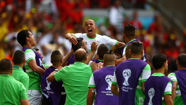 The Algeria squad lift Feghouli in celebration