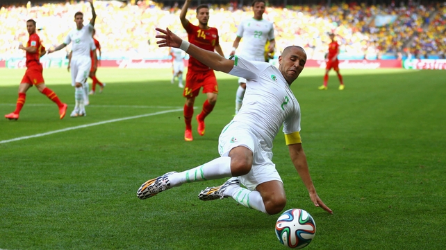 Algeria defender Madjid Bougherra reaches for the ball, as Belgium begins to apply steady pressure in the second half of play