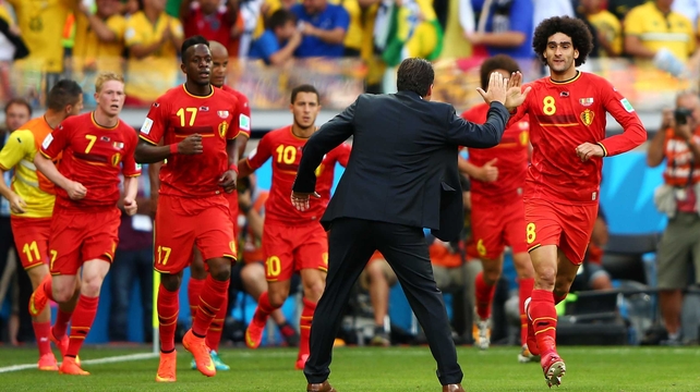 Fellaini high fives Belgium coach Marc Wilmots following the crucial play