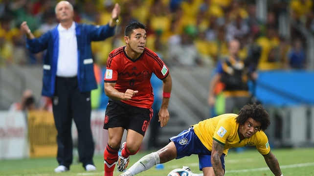 Scolari, equally frustrated, watches Mexico midfielder Marco Fabian beat Brazil defender Marcelo to the ball, as the final minutes tick by