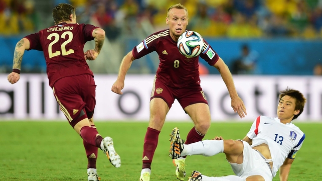 The first half saw only one shot on target, proving one of the slowest openings seen so far. Here, Russia midfielder Denis Glushakov and Korea forward Koo Ja-Cheol compete for the ball