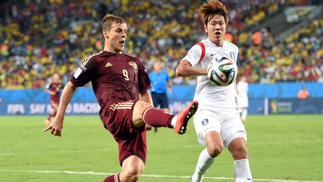 Russia forward Alexander Kokorin extends his reach against Korean defender Kim Young-Gwon