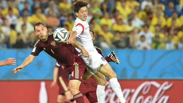 Doing little to smash the stalemate, Russia defender and captain Sergey Ignashevich and Korea midfielder and captain Lee Chung-Yong collide while watching the ball float serenely away