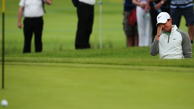 Rory McIlroy reacts after a bunker shot on the 11th during Day One