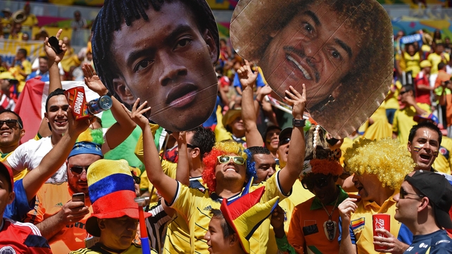 Colombia fans came out in force, with many sporting blonde afro wigs to honour past national great Carlos Valderrama (pictured here, as the right of the two giant heads)
