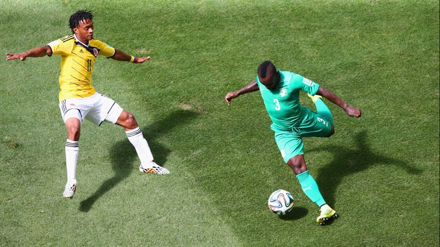 The two sides split the possession percentage to start. Here, Ivory Coast defender Arthur Boka (R) clears the ball away with Colombia midfielder Juan Cuadrado close by