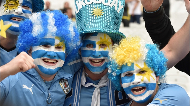 While a few cheerful fans of Uruguay painted their faces with the flag of their country to show some support...