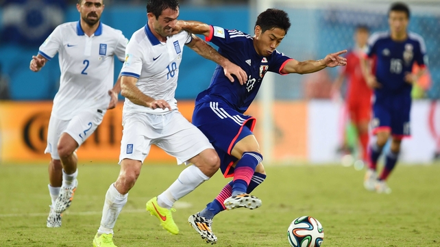 While Japan kept something to the tune of 70 percent possession during the second half, Greece managed to keep the score sheet clean. Here, Greece midfielder Giorgos Karagounis sticks close to Japan forward Shinji Kagawa