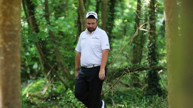 Shane Lowry searches in vain for his ball on the 18th on day two