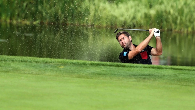 England's Robert Rock birdies the 14th from a bunker during the second round