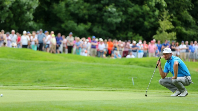 Graeme McDowell lines up a putt on day three