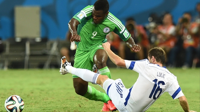 Senad Lulic challenges Nigeria's forward Emmanuel Emenike