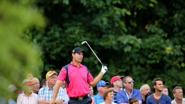 Padraig Harrington watches his tee shot go into the water on day three