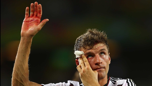 Thomas Muller salutes the crowd after being in the wars