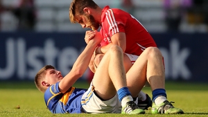 Cork's Eoin Cadogan consoles Steven O'Brien of Tipperary after a brave effort from the Premier County ended in defeat