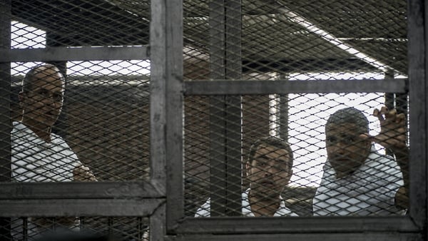 Peter Greste (L) and his two colleagues were each jailed for seven years