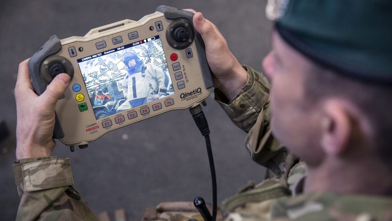 A soldier operates the control unit of a bomb disposal robot as part of a showcases of future specialist capabilities