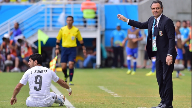 Italy coach Cesare Prandelli gestures next to Uruguay forward Luis Suarez