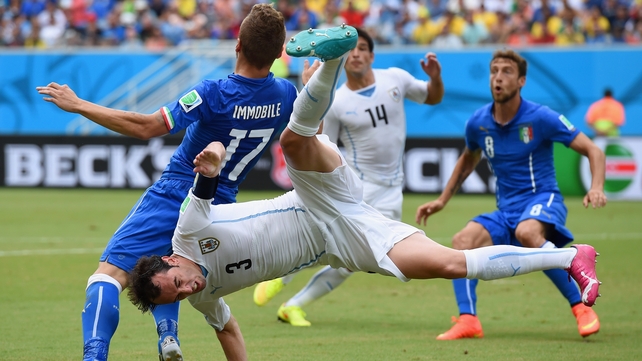 Diego Godin of Uruguay and Ciro Immobile of Italy compete for the ball