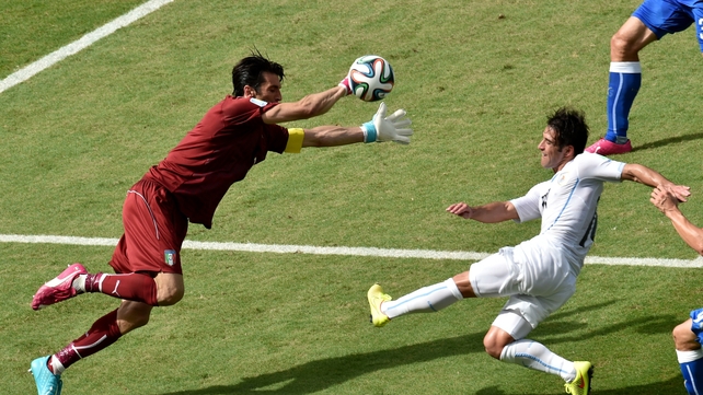 Bravery from Italy goalkeeper and captain Gianluigi Buffon as he advances towards Uruguay's Nicolas Lodeiro