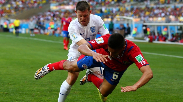 James Milner of England competes for the ball against Oscar Duarte of Costa Rica