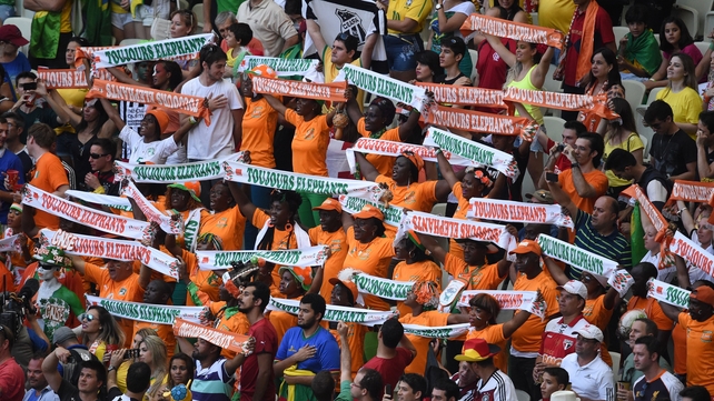 Ivory Coast fans cheer for their team before the start of the game against Greece