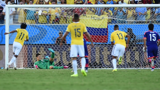 ... Japan's goalkeeper Eiji Kawashima is unable to stop it...