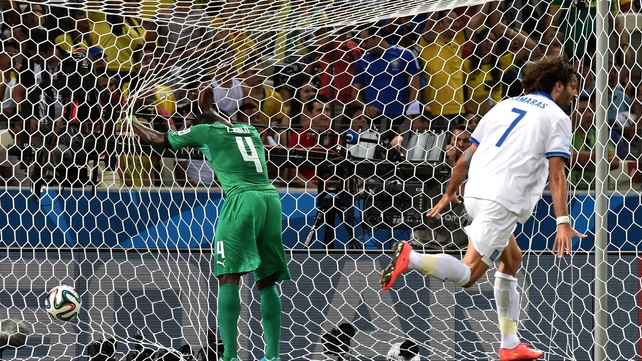 Kolo Toure reacts as Georgios Samaras, who set it up, celebrates Greece's opening goal