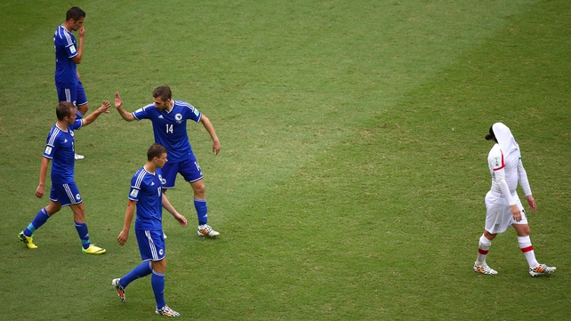 Bosnia-Herzegovina players celebrate their second goal as it's all a bit much for an Iranian player
