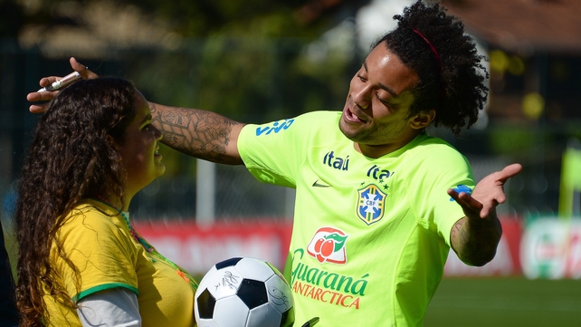 Meanwhile, elsewhere, Marcelo embraces a fan before a training session at Brazil's Granja Comary training complex