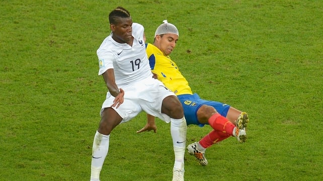The bandaged Christian Noboa battles for the ball with Paul Pogba