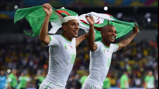 Players proudly ran with their flag after the match, which represented Algeria's first trip to a World Cup knockout stage in their history
