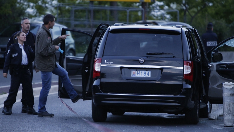 Police investigate a car at the site where a shooting injured Helene Pastor occured