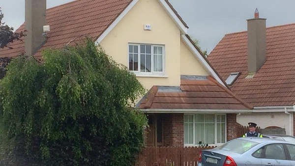 Forensic investigators carry out an examination of the house